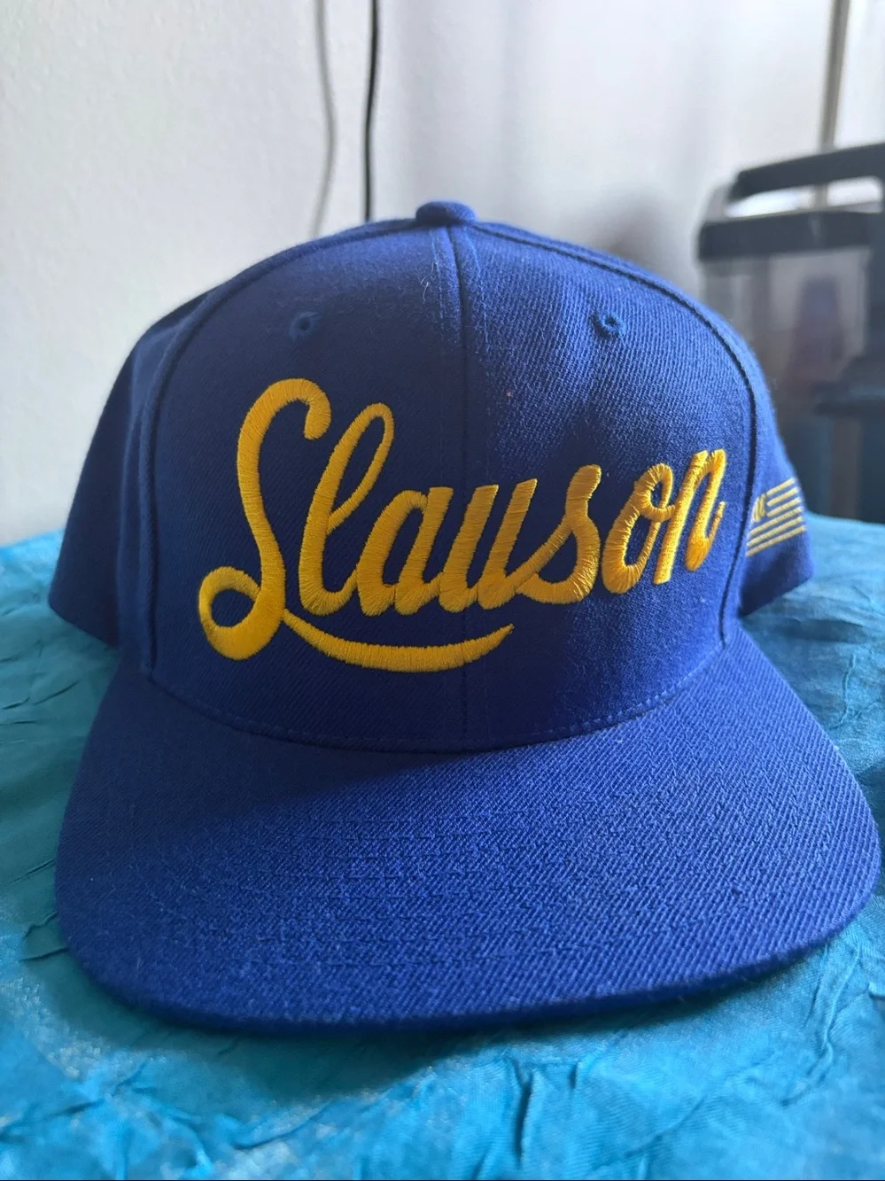 Slauson embroidered in yellow on a 6-panel royal blue adjustable snapback